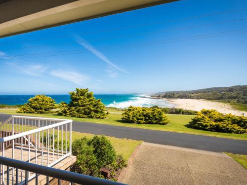 a balcony with a view of the beach at 120 Ocean Parade Dalmeny in Dalmeny