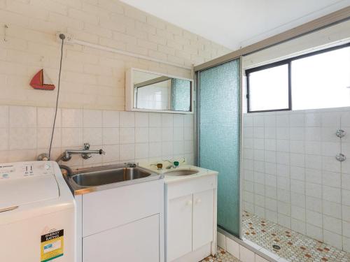 a small kitchen with a sink and a window at Apollo Unit 23 First Floor in Narooma
