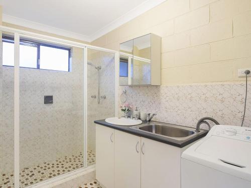 a bathroom with a sink and a shower at Apollo Unit 8 1st Floor in Narooma