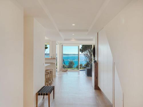 a hallway with a view of the ocean from a house at Dollini Ocean Unit 1 in Dalmeny