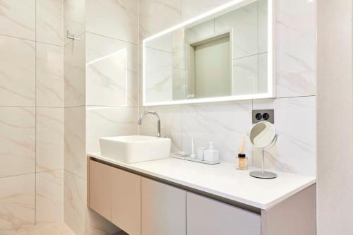 a white bathroom with a sink and a mirror at Tops10 Resort Donggang Cistar in Yeongwol
