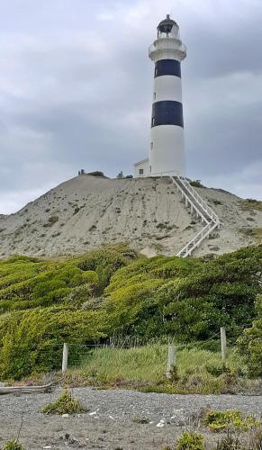a lighthouse sitting on top of a hill at Flaxbourne Motels in Ward