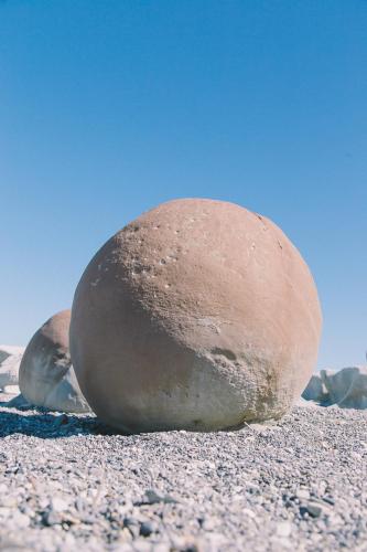 a large rock sitting on the ground on a beach at Flaxbourne Motels in Ward