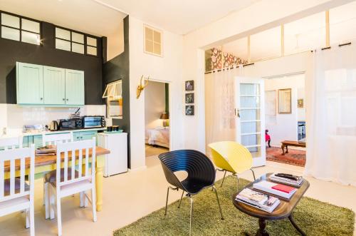 a kitchen and living room with a table and chairs at Skyview Manor in Stellenbosch