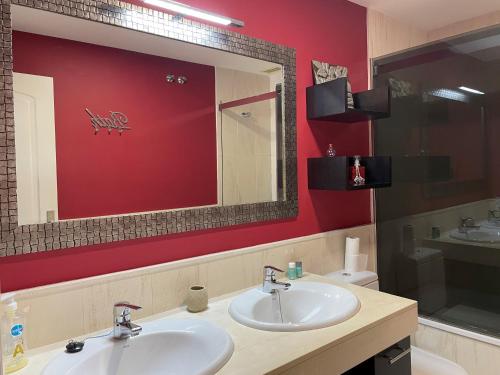 łazienka z 2 umywalkami i czerwoną ścianą w obiekcie Mi Capricho, Luxury Apartment P 10 w mieście Mijas Costa