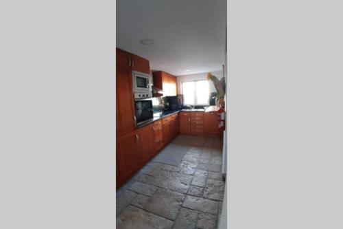 a view of a kitchen from the hallway at A Casa da Foz Moradia com vista mar in Sesimbra