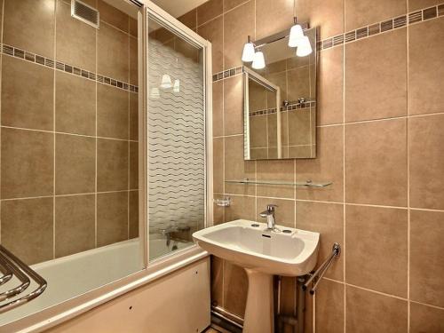 a bathroom with a sink and a shower and a mirror at Appartement La Plagne, 2 pièces, 5 personnes - FR-1-455-56 in La Plagne