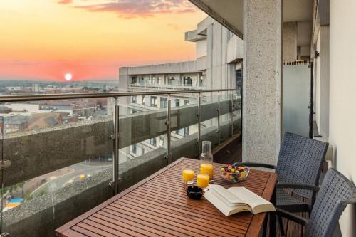a table with a book and glasses on a balcony at Large 2 Bedroom Apartment in Ashford with PARKING in Ashford