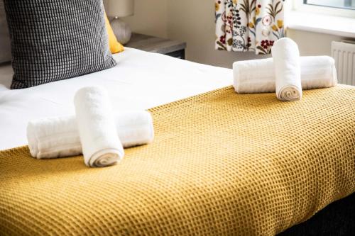 a group of rolled towels on a bed at Large 2 Bedroom Apartment in Ashford with PARKING in Ashford