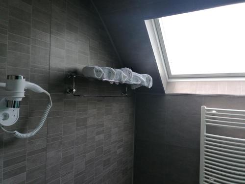 a bathroom with a shower with a window at Hotel Prins van Oranje in Diest