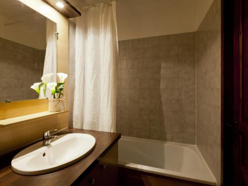 uma casa de banho com um lavatório e uma banheira em Studio Brides-les-Bains, 1 pièce, 4 personnes - FR-1-512-143 em Brides-les-Bains