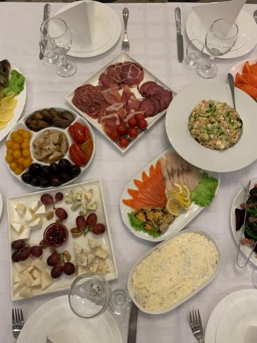 a white table with plates of food on it at Yunist in Ivano-Frankivsk