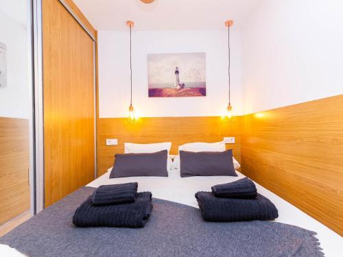 a bedroom with a bed with two pillows on it at Lighthouse Friendly Holiday Home in Playa del Ingles