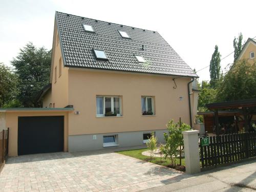 a house with a black roof and a garage at Apartment Reininghaus - Low budget in Graz