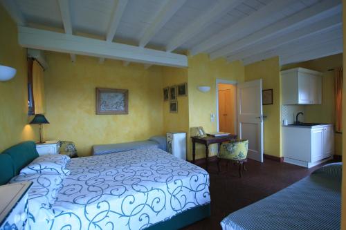 a bedroom with a bed and a table and a kitchen at Agriturismo Natta Di Monte Tabor in Celle Ligure