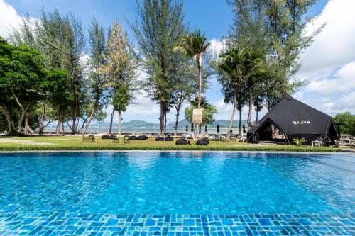 a swimming pool in front of a resort at The Mangrove Phuket by Blu Monkey in Panwa Beach