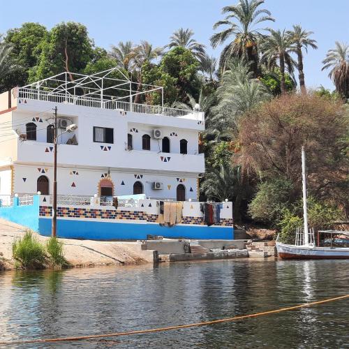 a cruise ship docked on the river at ABAZIDO Nubian Guest House in Aswan