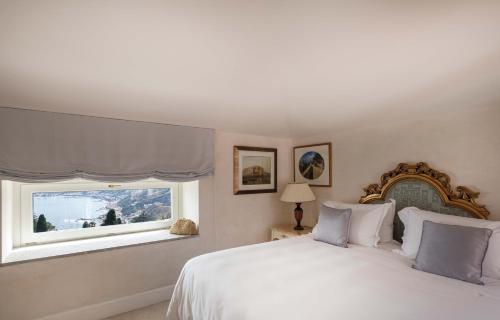 a bedroom with a white bed and a window at Grand Hotel Timeo, A Belmond Hotel, Taormina in Taormina