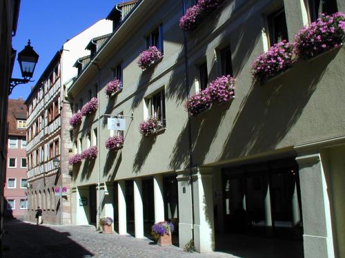 a building with flower boxes on the side of it at Hotel Agneshof Nürnberg in Nuremberg