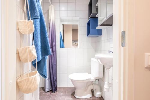 a bathroom with a toilet and a sink at Eduard House by Larsen in Tallinn