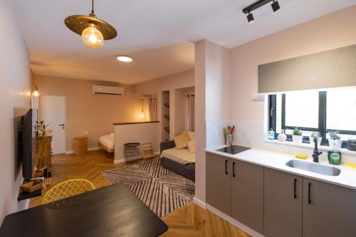 a kitchen and living room with a table and a couch at Eilat vacation house דירות נופש אילת in Eilat