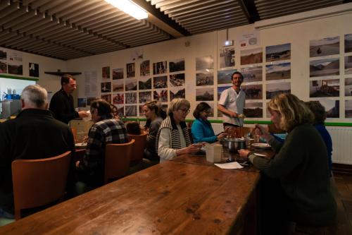 a group of people sitting around a table in a restaurant at Auberge de Jeunesse HI Serre-Chevalier in La Salle Les Alpes
