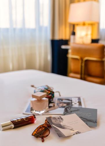 a table with a pair of glasses and a bottle on it at Villa Brown Tel-Aviv, a member of Brown Hotels in Tel Aviv