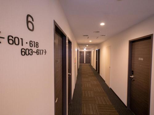 a corridor of an office building with a long hallway at Hotel Best Price Kochi in Kochi