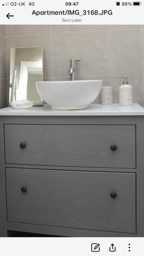 a bathroom vanity with a sink and a white sink at The Loft , Portrush in Portrush