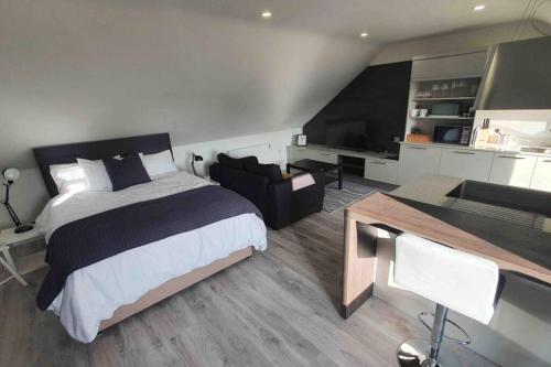 a bedroom with a bed and a living room at The Loft , Portrush in Portrush
