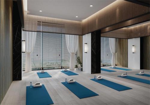 a yoga room with blue mats on the floor at FLC City Hotel Beach Quy Nhon in Quy Nhon