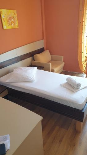 a room with two beds and a couch at Hotel Posejdon Vela Luka in Vela Luka