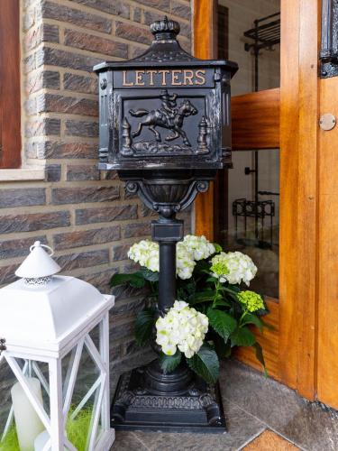 a black lantern with flowers on a porch at Hotel Alte Post in Krefeld