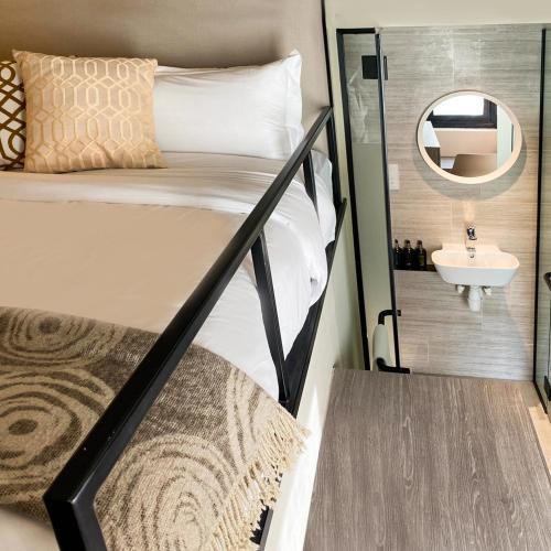 a bedroom with a bunk bed with a mirror and a sink at ST Signature Jalan Besar, SHORT OVERNIGHT, 13 Hours, 6PM-7AM in Singapore