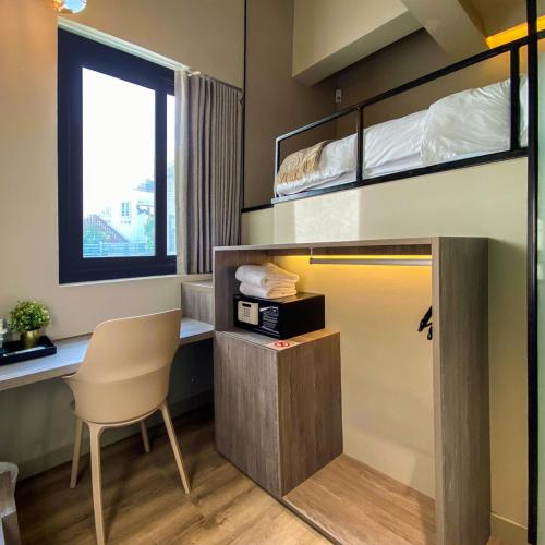 a room with a desk and bunk beds at ST Signature Jalan Besar, SHORT OVERNIGHT, 13 Hours, 6PM-7AM in Singapore