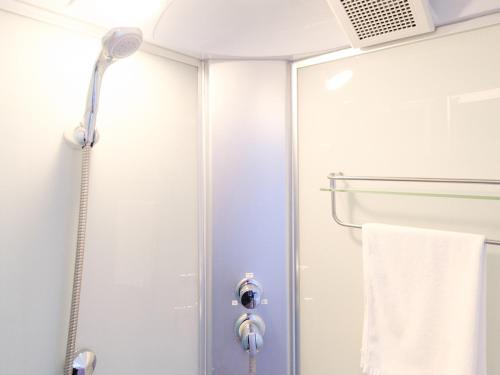 a shower with a glass door and a towel at Hotel Shion no Umi - Vacation STAY 13823v in Miyako Island