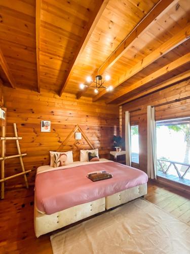 a bedroom with a bed in a wooden room at Samed sand sea resort in Ko Samed