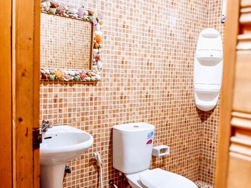 a bathroom with a toilet and a sink at Samed sand sea resort in Ko Samed