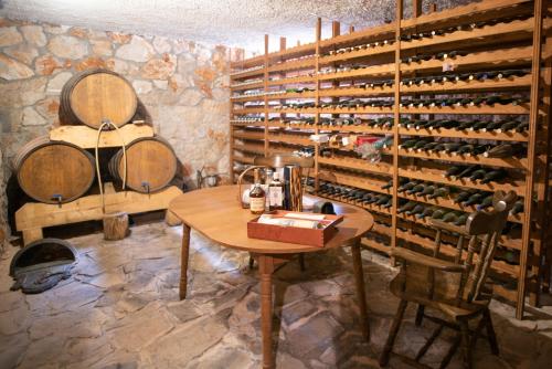 a room with a table and a bunch of wine bottles at Villa Amalia in Široki Brijeg