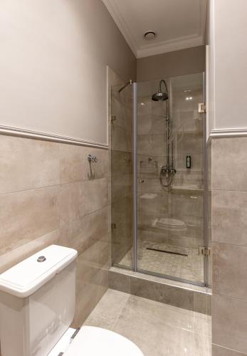 a bathroom with a shower with a toilet and a sink at Dvoryansky Hotel in Odesa