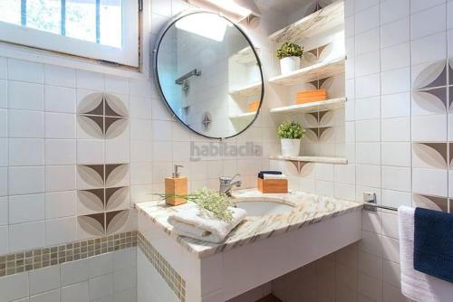 a bathroom with a sink and a mirror at El Chalet del Montseny in Seva