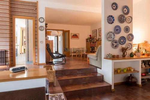 a living room with blue plates on the wall at El Chalet del Montseny in Seva