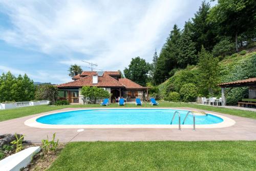 a swimming pool in a yard with a house at LovelyStay - Toca dos Coelhos in Marco de Canaveses