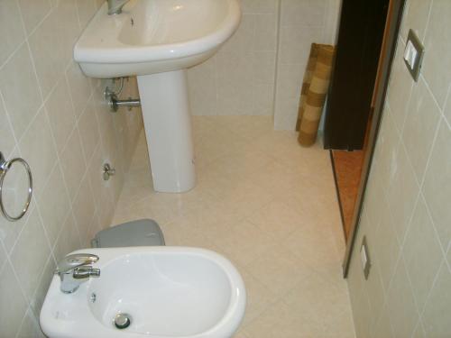 a bathroom with a sink and a toilet at Antica Vittoria in Vittoria