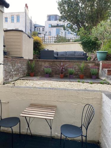 two chairs and a bench and a table and two chairs at Central Brighton garden studio, close to seafront in Brighton & Hove