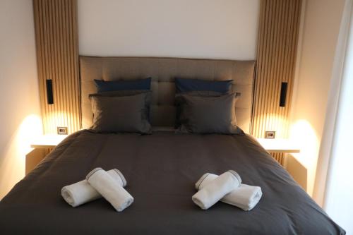 two towels on a bed with two pillows on it at W Apartman in Vrnjačka Banja
