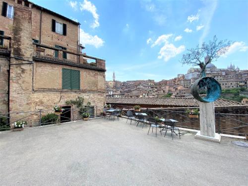 a large patio in a building with tables and chairs at CAMPOREGIO 31- In Centro con Vista sul Duomo in Siena