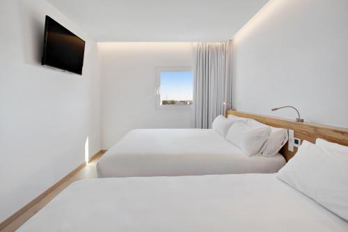 En eller flere senger på et rom på B&B HOTEL Porto Expo Aeroporto