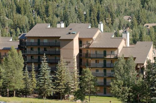 a large apartment building in the mountains with trees at Vantage Point #408 Condo in Vail