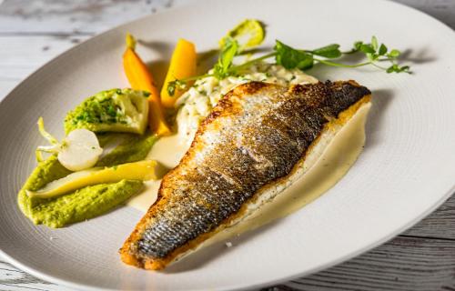 a plate of food with fish and vegetables on it at Hôtel SPA du Lac de Madine - Maison DRAPIER in Heudicourt-sous-les-Côtes